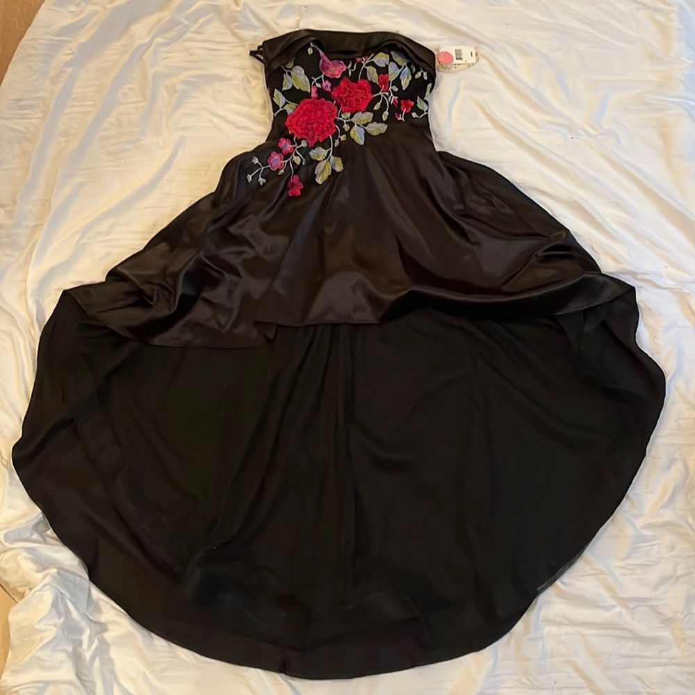 Black hi-low dress with a floral pattern front top and a corset back.